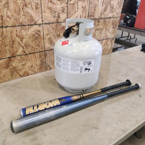 Empty bbq tank, baseball bats