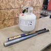 Empty bbq tank, baseball bats