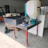 Grass seeder for back of side by side on platform sitting on rolling stand, w monitor and instruction book