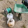 2 Empty bbq tank, hose on reel, wheelbarrow