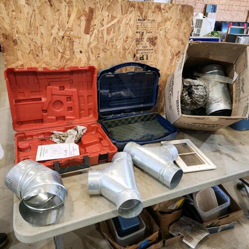Empty tool cases, various sized duct fittings