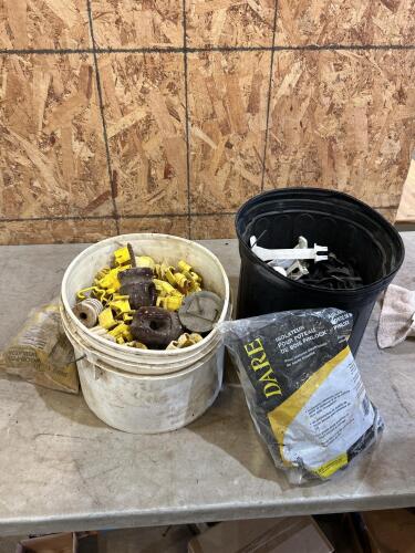 2 buckets of electric fencing insulators