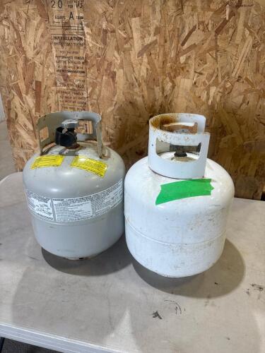 1 - Empty and 1 - 3/4 full bbq propane tank