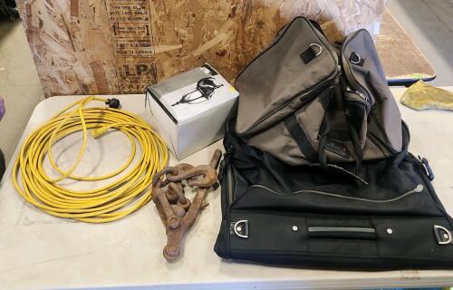 Porch light, ext cord, chain binder, duffel bag, suit bag
