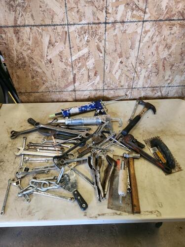 Caulking gun, pipe wrench, assorted tools