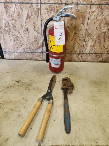 18" Pipe wrench, 15" charged fire extinguisher, pruners