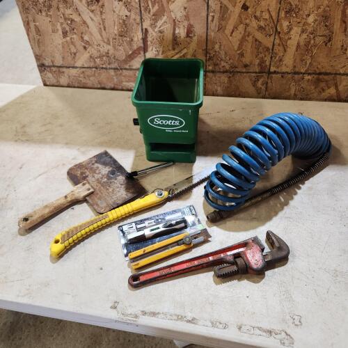 Air hose, grass spreader, 14" pipe wrench, etc.