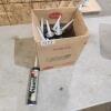 9 Grey tubes of caulking
