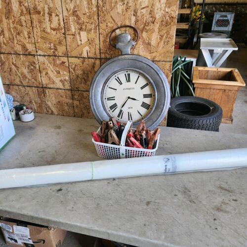 Booster cable clamps, clock, roll of plastic