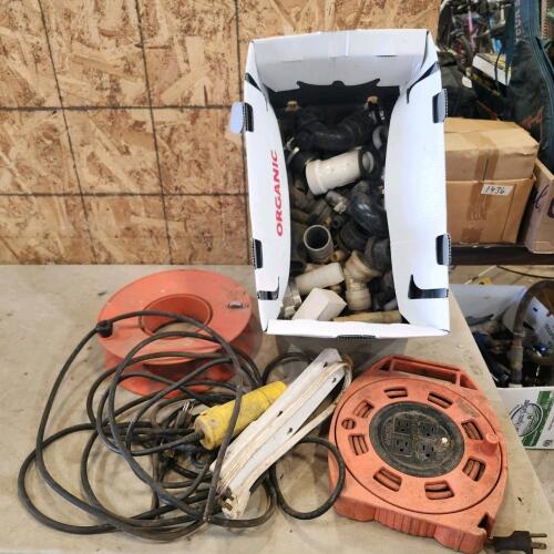 Various sized plastic plumbing fittings, cord, trouble light