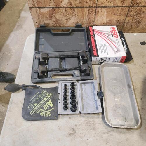 Inflatable pry bar, coil spring compressor, stud removers, spark plug wires
