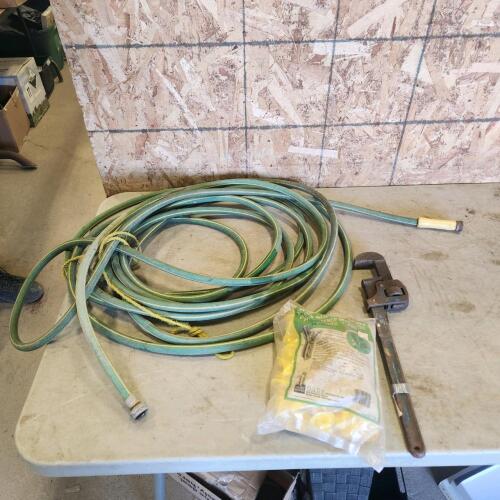 Rubber garden hose, T post insulators, pipe wrench