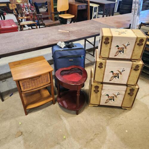 Suitcases, small tables, various sized trunks